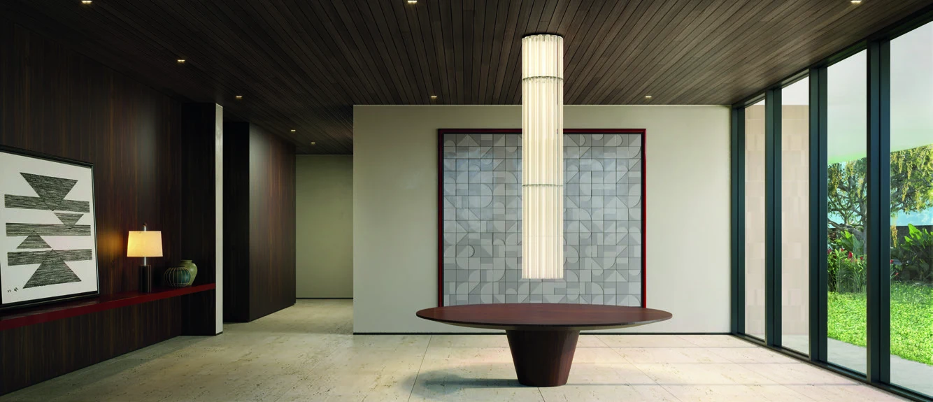 Lobby do térreo da torre Sole, com mesa redonda, luminária alta e janelas para o jardim