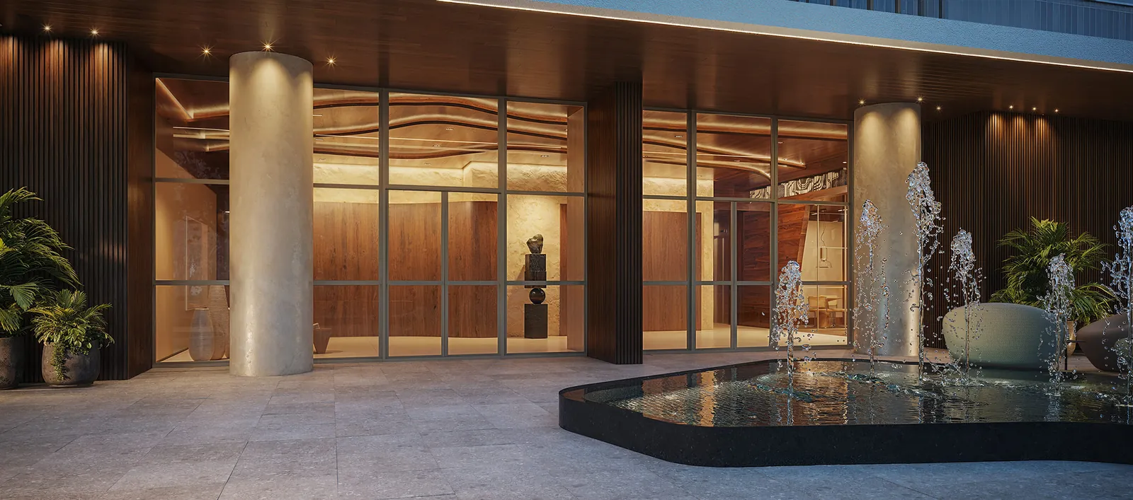 Acesso ao lobby com colunas, espelho d'água e portas de vidro iluminadas